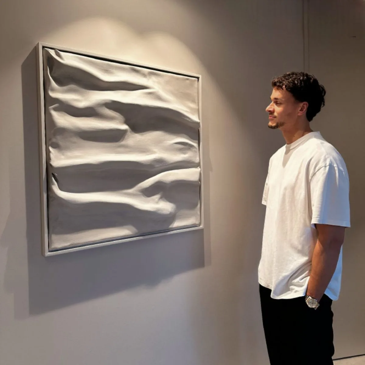 Lazlo Jacobs next to one of his relief works